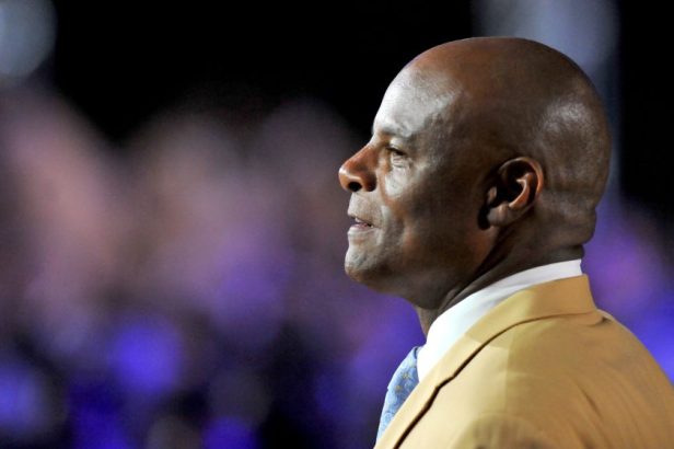 Hall of Fame quarterback Warren Moon is greeted by the crowd during the Pro Football Hall of Fame Gold Jacket Dinner on August 4, 2016.