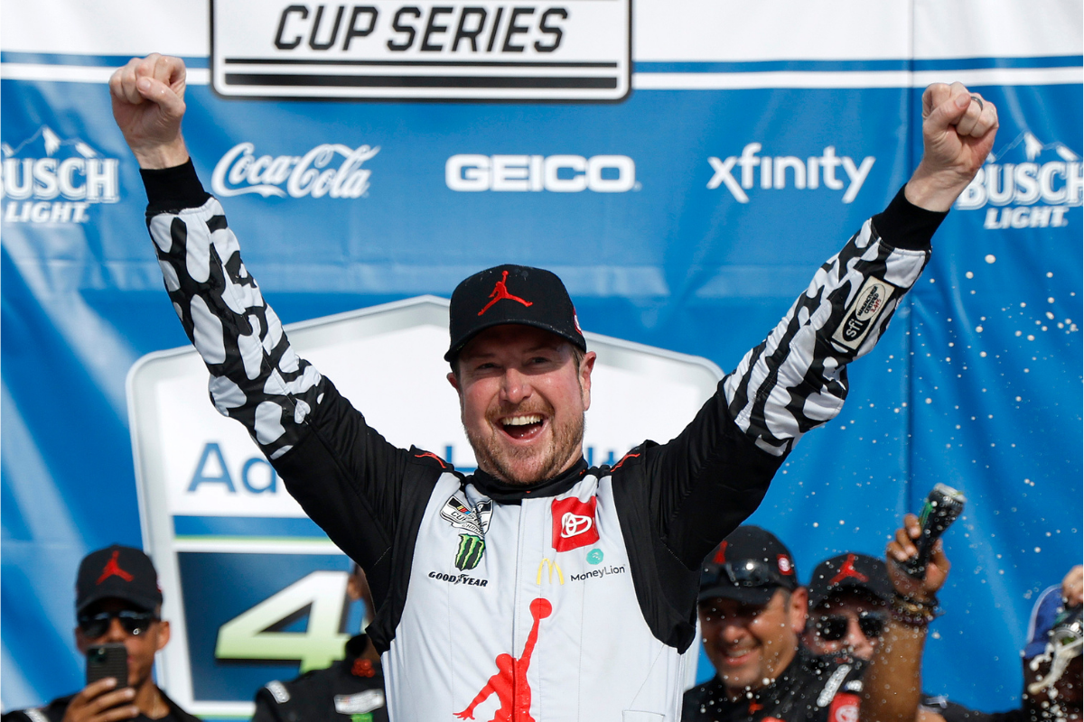 Kurt Busch celebrates in victory lane after winning the NASCAR Cup Series AdventHealth 400 at Kansas Speedway on May 15, 2022