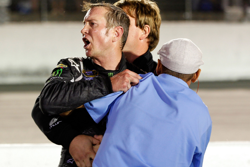 Kurt Busch is held back during scuffle with Ryan Newman during the Bojangles' Southern 500 at Darlington Raceway on May 12, 2012