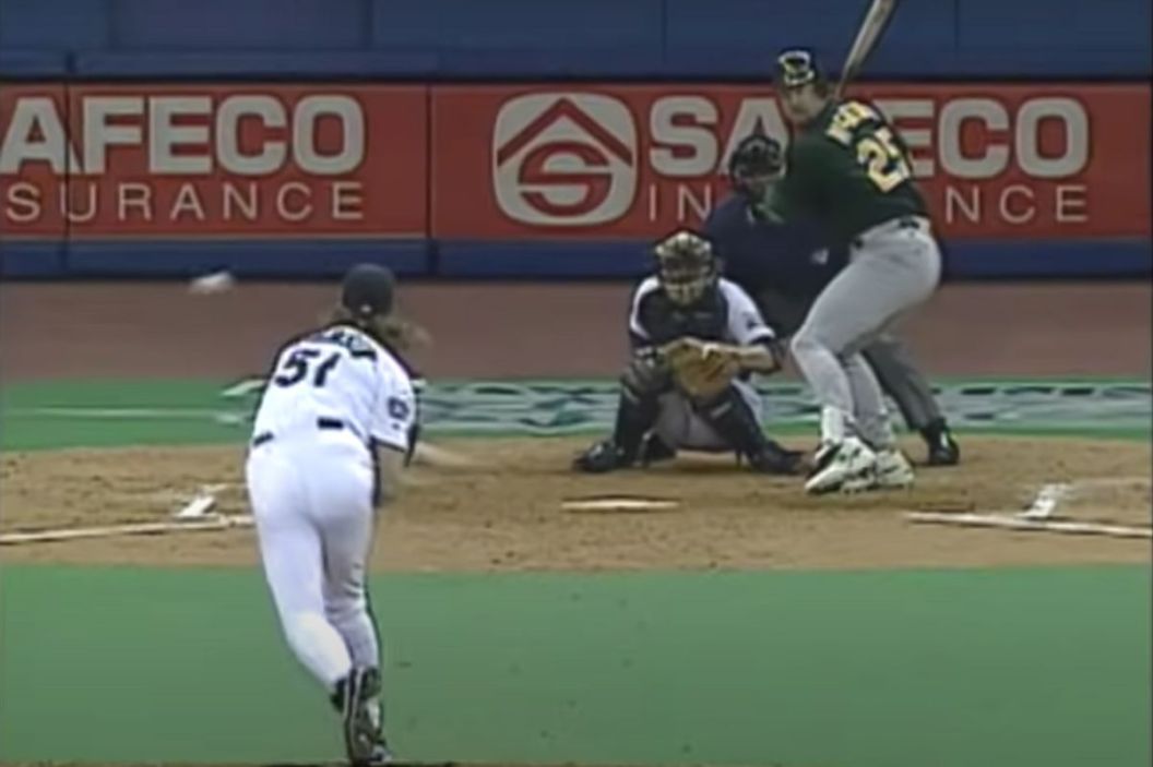 Randy Johnson throws a pitch to Mark McGwire.