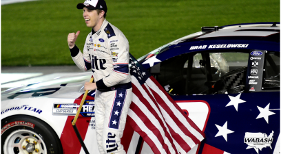 Brad Keselowski celebrates with the American flag after winning the 2020 Coca-Cola 600 at Charlotte Motor Speedway