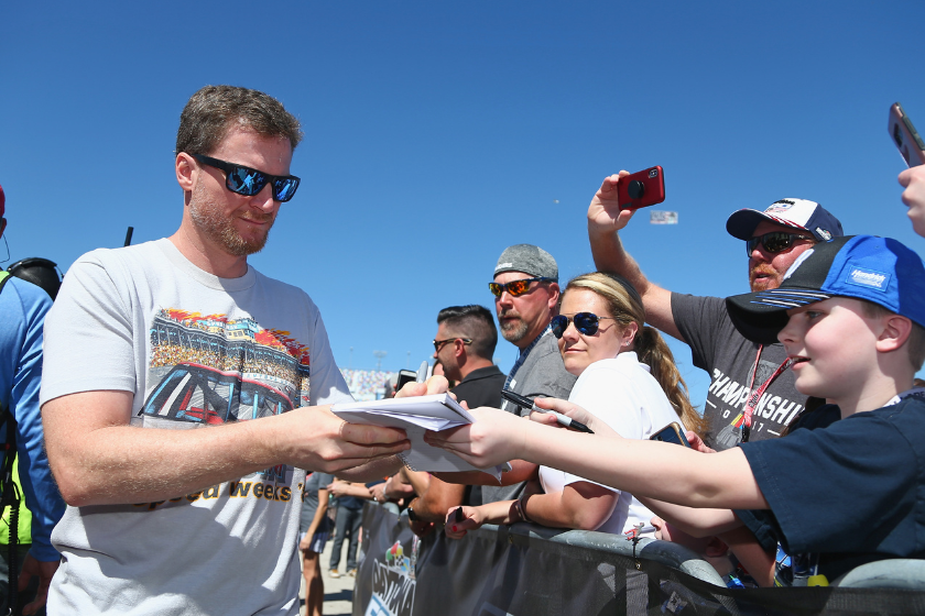 Dale Earnhardt Jr signs autographs prior to the start of the 2018 Daytona 500