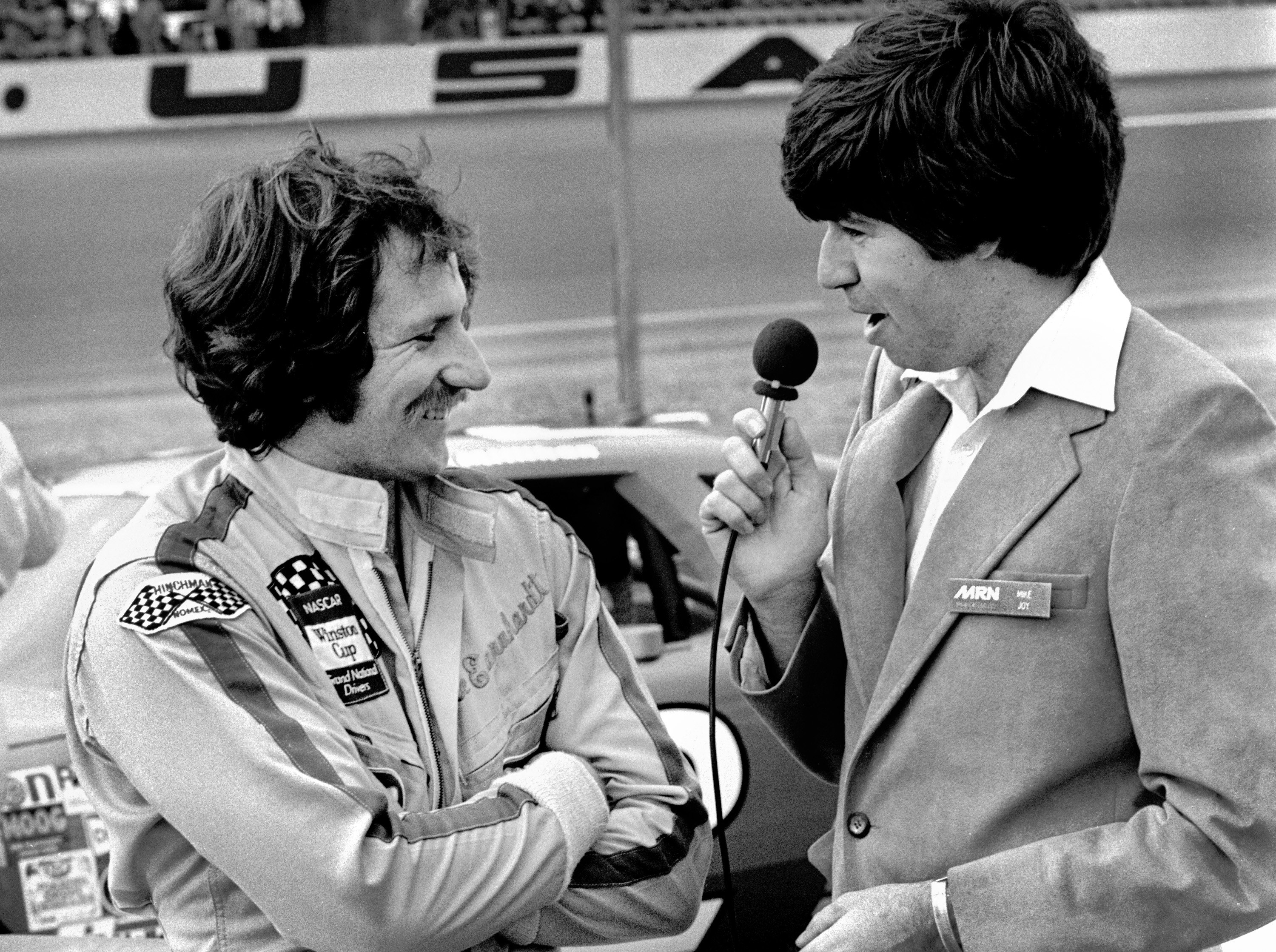Mike Joy interviews Dale Earnhardt Sr prior to the start of the 1982 Daytona 500 at the Daytona International Speedway on February 14, 1982 in Daytona Beach, Florida