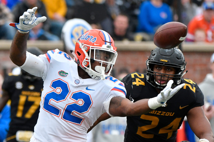 Running back Lamical Perine #22 of the Florida Gators reaches out to catch a pass against Terez Hall #24 of the Missouri Tigers 