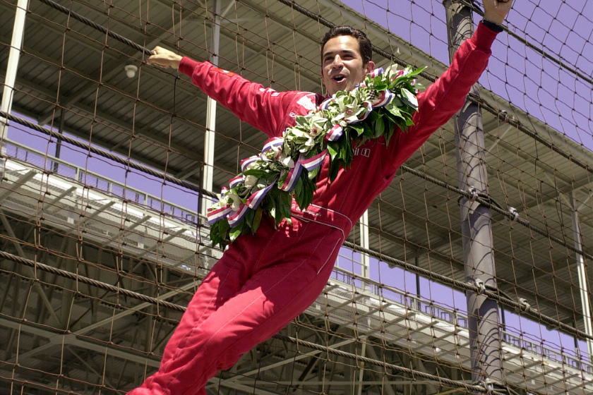 helio castroneves hanging off fence after winning 2001 indy 500