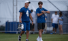 Adam Vinatieri walks onto the field with his son AJ Vinatieri before the Indianapolis Colts training camp practice on July 26, 2019.