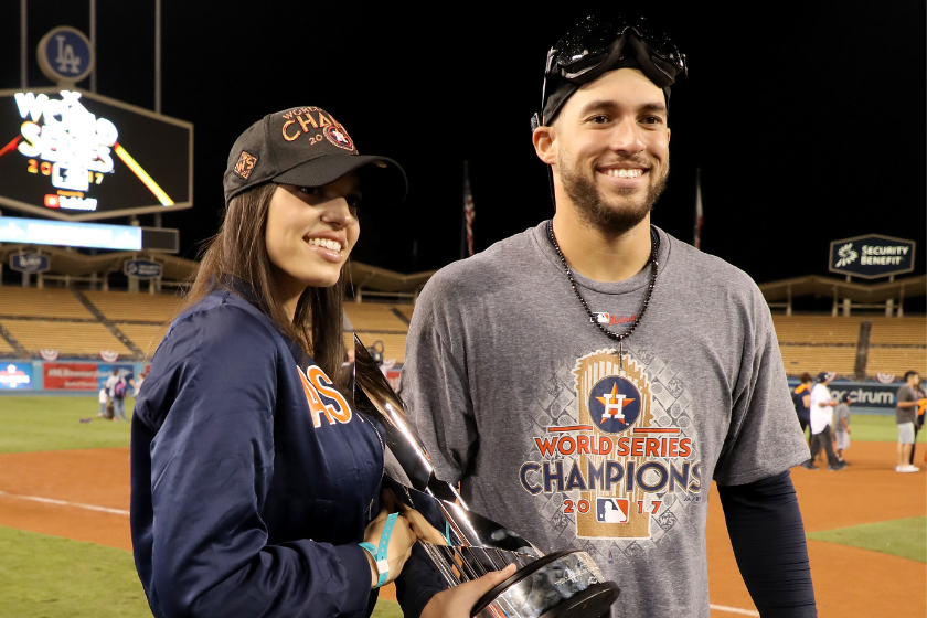 George Springer #4 of the Houston Astros holds the 2017 Willie Mays World Series Most Valuable Player (MVP) Award as he poses with fiancee Charlise Castro after defeating the Los Angeles Dodgers 5-1 in game seven to win the 2017 World Series