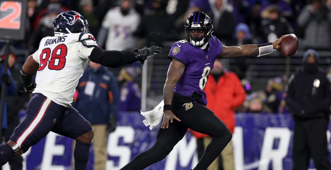 BALTIMORE, MARYLAND - JANUARY 20: Lamar Jackson #8 of the Baltimore Ravens scores an 8 yard touchdown against Sheldon Rankins #98 of the Houston Texans during the fourth quarter in the AFC Divisional Playoff game at M&T Bank Stadium on January 20, 2024 in Baltimore, Maryland.