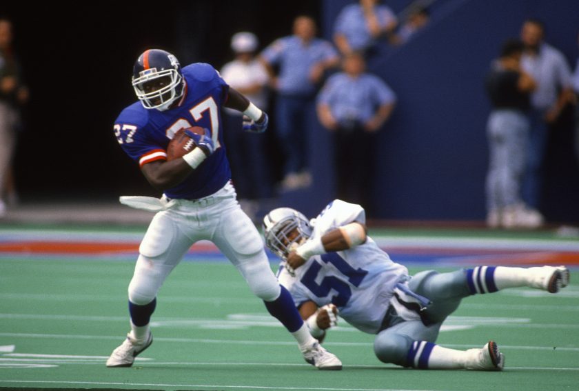 Rodney Hampton carries the ball against the Dallas Cowboys during an NFL football game September 30, 1990.