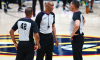 Three NBA refs discuss a call.