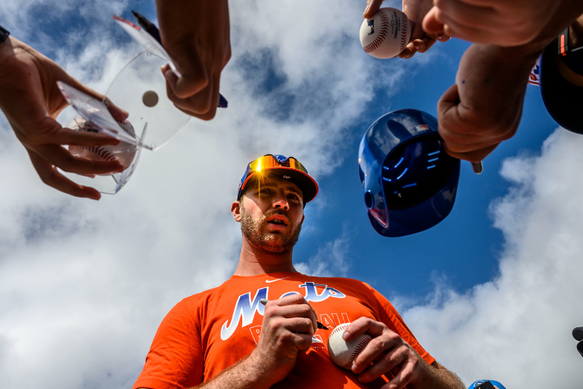 New York Mets infielder Pete Alonso signs autographs during a spring training workout