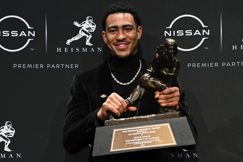 Bryce Young with his 2021 Heisman Trophy