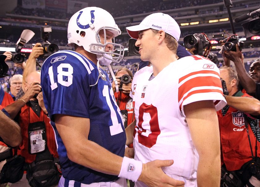 Peyton and Eli Manning embrace after playing each other in 2010.