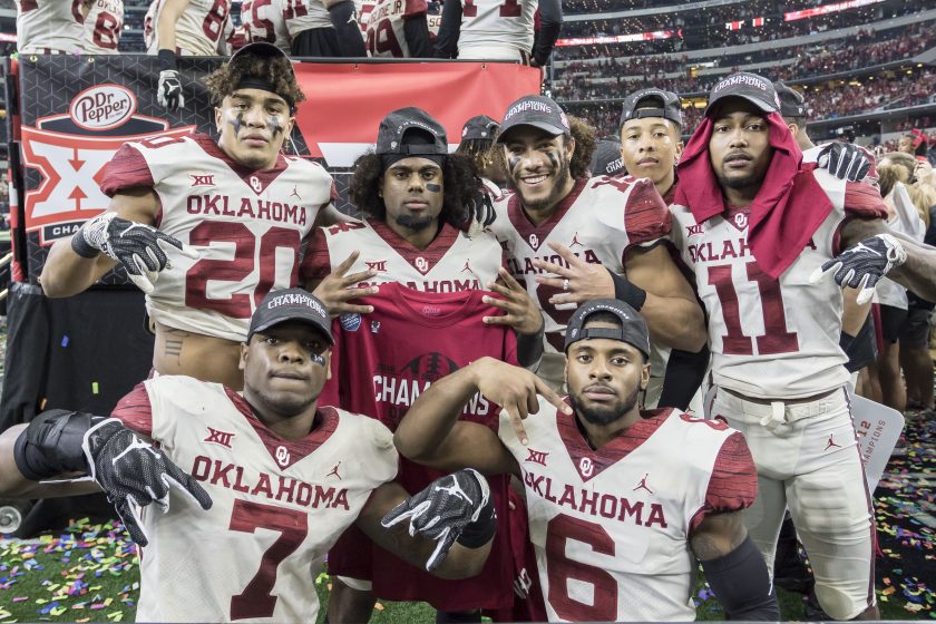 Oklahoma players do the horns down in 2018