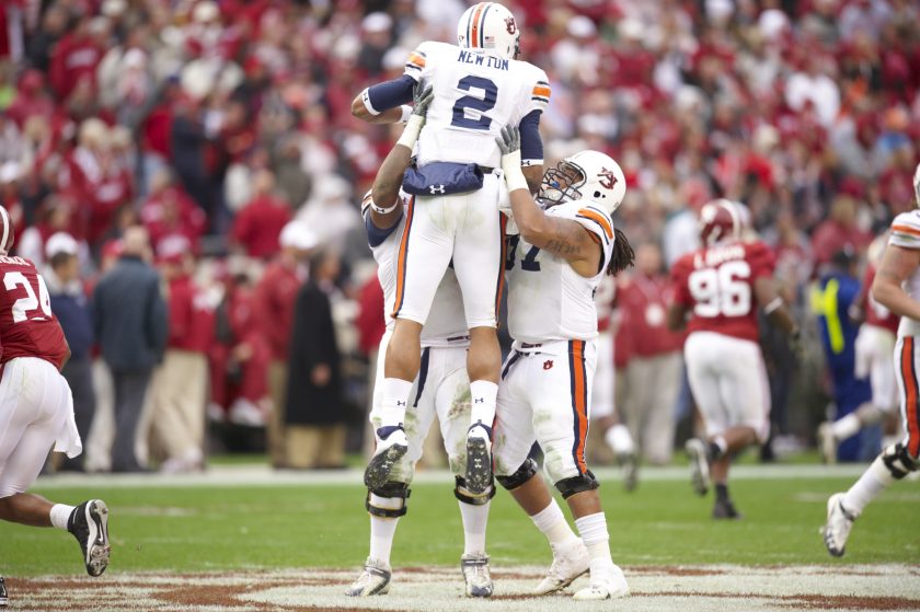 Cam Newton is lifted by teammates at the 2010 Iron Bowl.