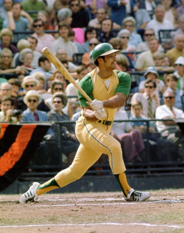 Reggie Jackson swings a bat during a 1971 game.