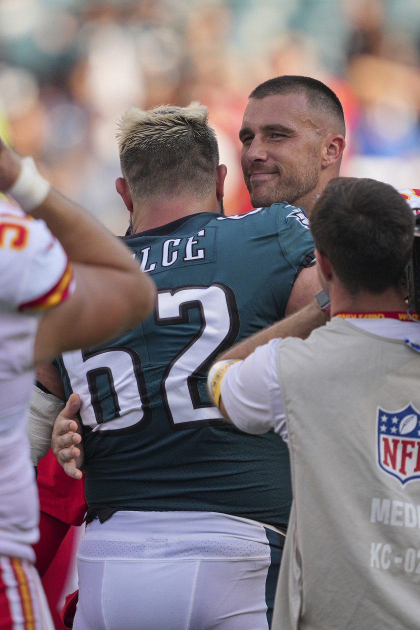 Jason and Travis Kelce hug after a 2021 NFL game.