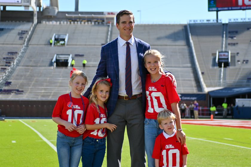 Eli Manning poses with his kids before an Ole Miss game in 2021.
