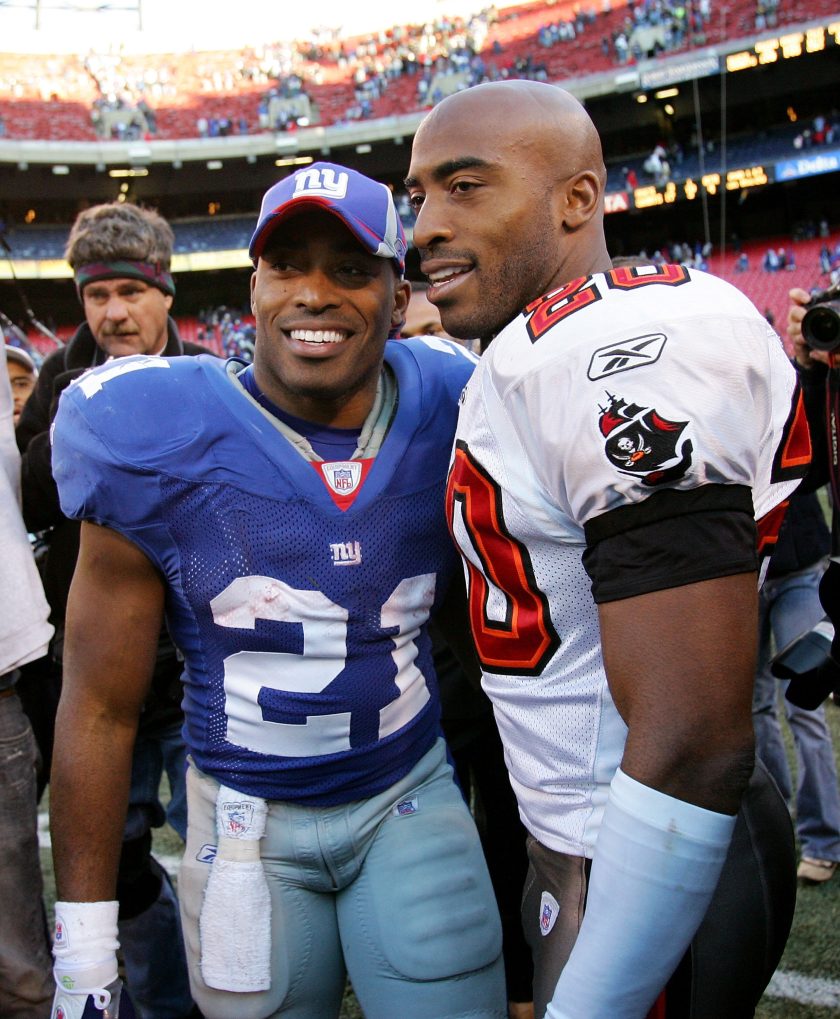 Ronde and Tiki Barber meet after a 2006 NFL Game.