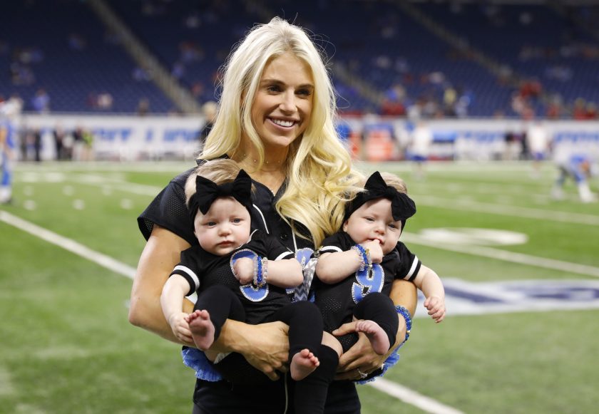 Kelly Stafford holds two of her kids before a Detroit Lions game.