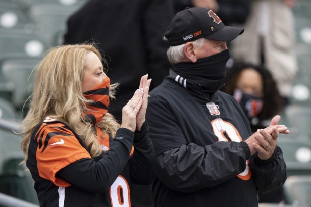 Jim Burrow and Robin Burrow cheer for the Bengals during a game in 2020.