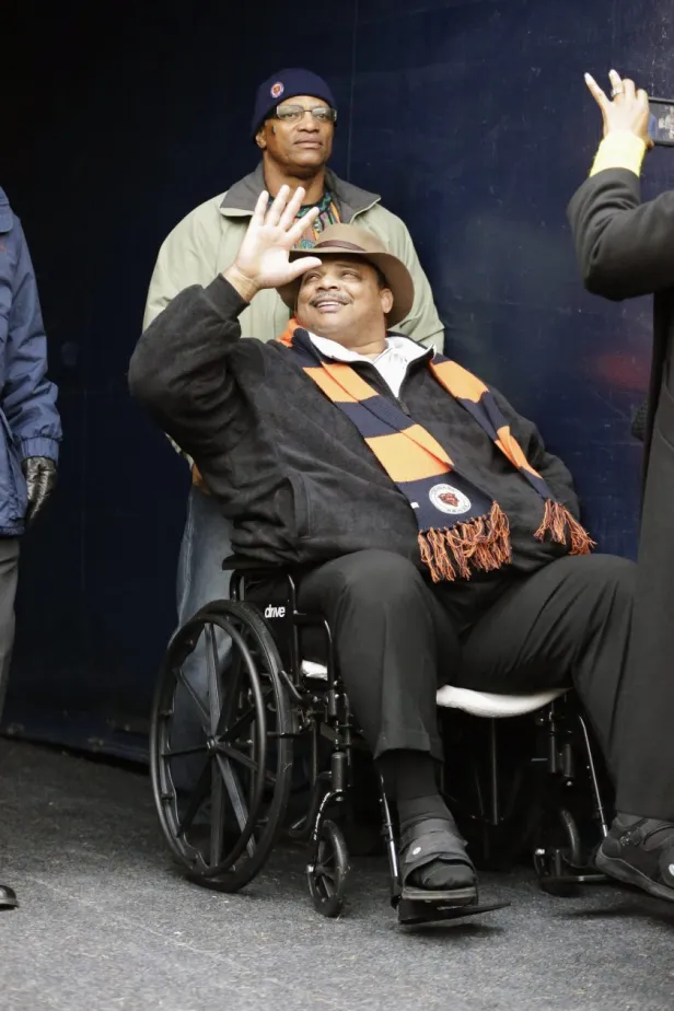 Former Chicago Bears player William Perry waves to fans during the first half of an NFL football game between the Bears and the Detroit Lions, Sunday, Jan. 3, 2016.