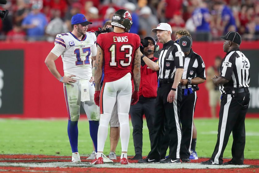 Josh Allen and Mike Evans meet for the coin flip before overtime in 2021.
