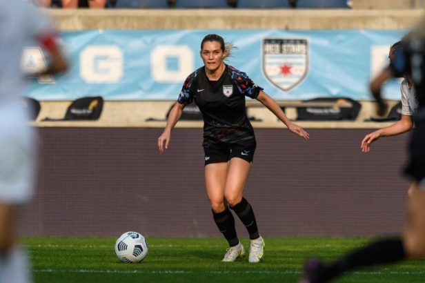 Kealia Watt dribbles the ball during a game between OL Reign and Chicago Red Stars at SeatGeek Stadium on July 18, 2021 .