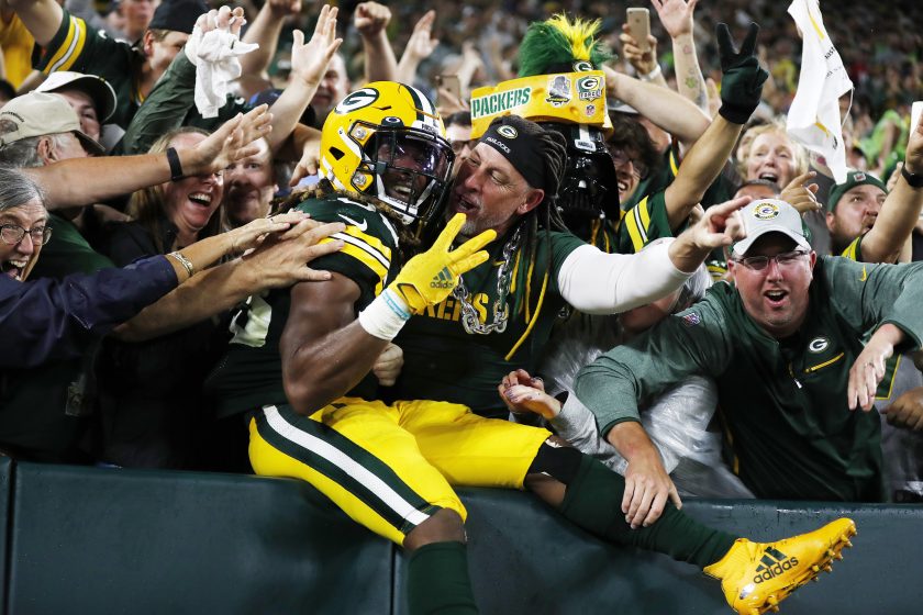 Aaron Jones does the Lambeau Leap against the Lions in 2021.