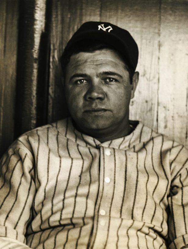 Babe Ruth poses for a photo in Yankees gear.