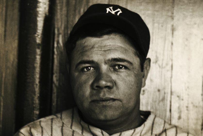 Babe Ruth poses for a photo in Yankees gear.