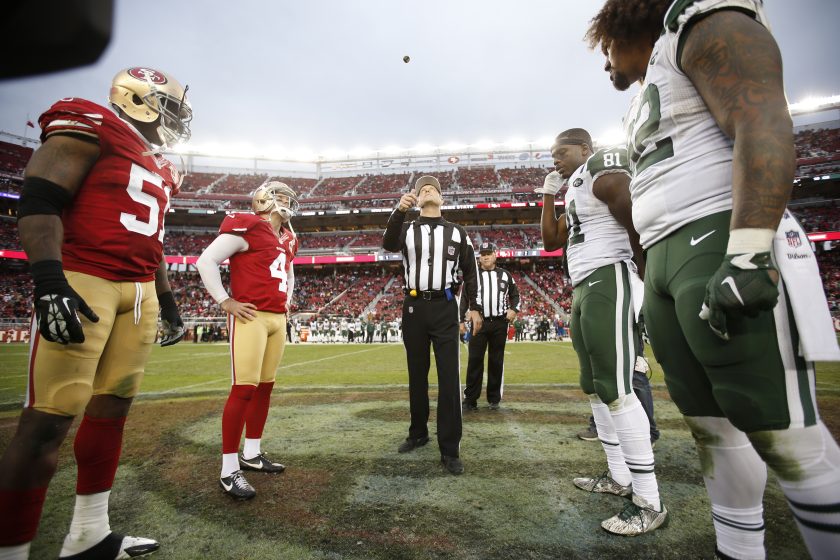 Jets and 49ers players meet for a coin flip in 2016.