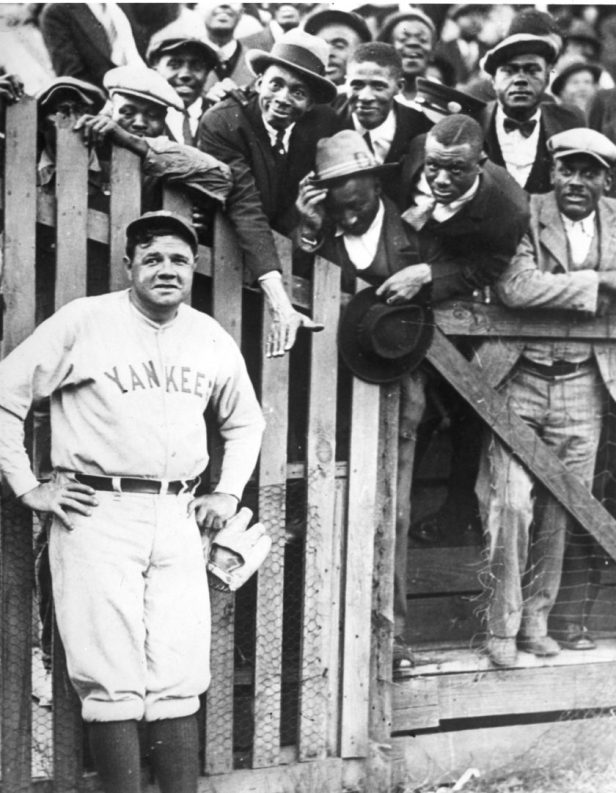 Babe Ruth takes a picture with fans in 1925.