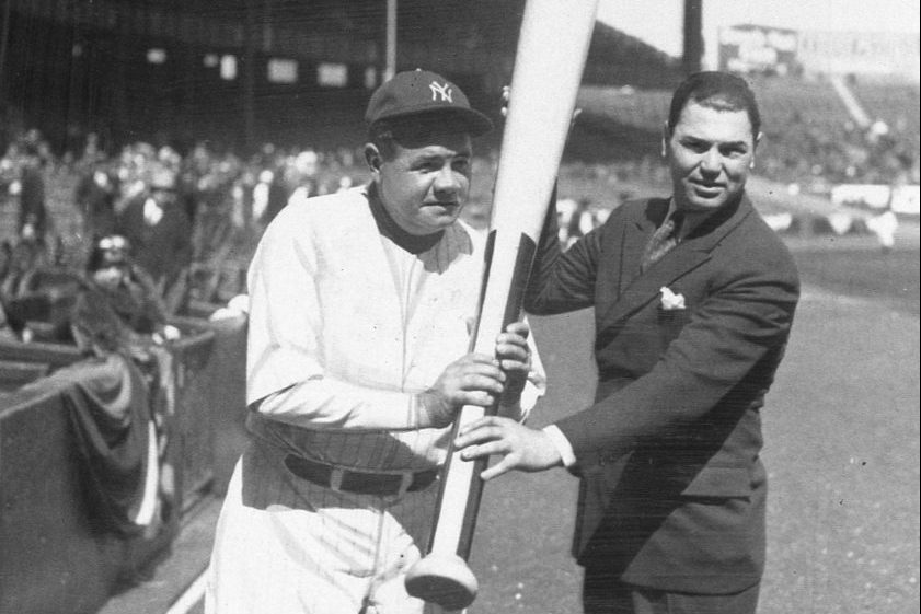Babe Ruth holds a large bat in 1929.