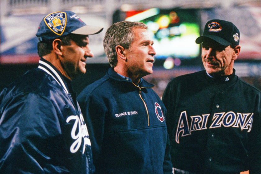 Manger Joe Torre #6 of the New York Yankees and Manager Bob Brenly #15 of the Arizona Diamondbacks pose for a photo on the field with President George W. Bush after the ceremonial first pitch prior to Game 3 of the 2001 World Series at Yankee Stadium