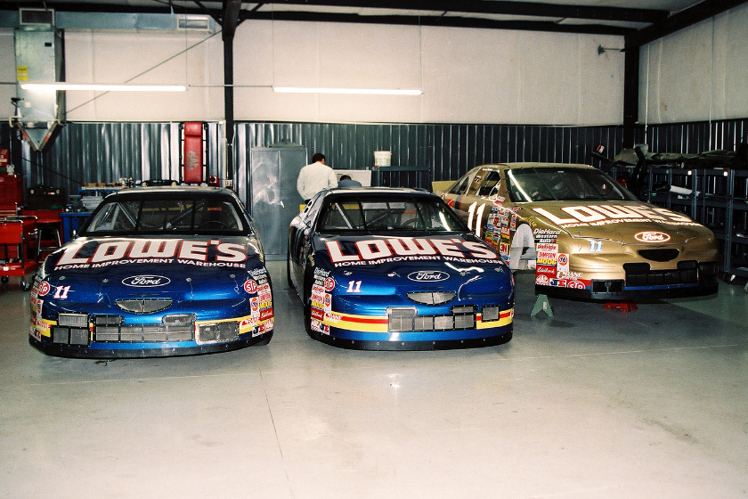 View of a trio of cars sponsored by Lowe's (among others) in Brett Bodine's garage, where they are housed during the NASCAR off-season, Charlotte, North Carolina, 1998