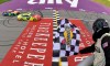 nascar official waves checkered flag at finish line
