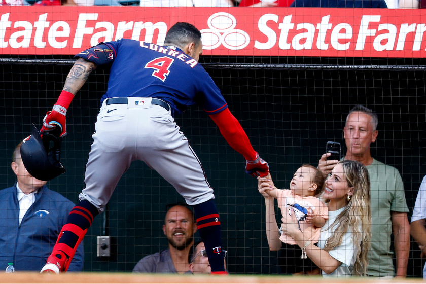 Carlos Correa #4 of the Minnesota Twins celebrates a home run with his wife Daniella Rodriguez and son, Kylo in the first inning against the Los Angeles Angels at Angel Stadium of Anaheim