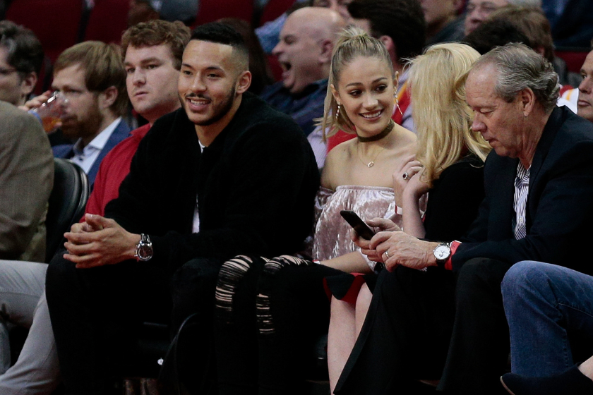 Carlos Correa of the Houston Astros and his fiance Daniella Rodriguez sit courtside with Houston Astros owner Jim Crane and his wife Whitney at Toyota Center