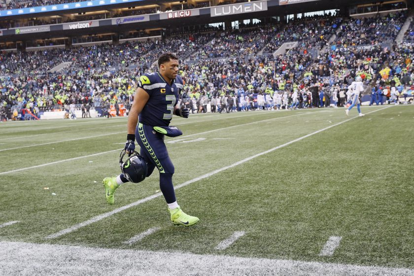 Russell Wilson runs off the field at halftime against the Detroit Lions at Lumen Field on January 02, 2022