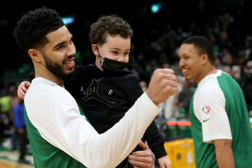 Boston Celtics holds his son Jayson Jr. after beating the Miami Heat in 2022.