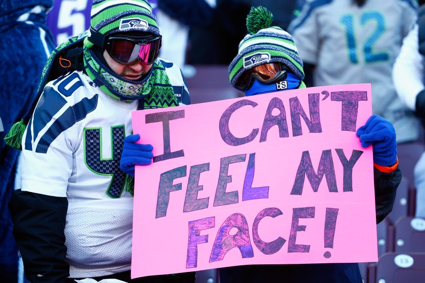 Seahawks fans hold a sign saying, "I can't feel my face!"