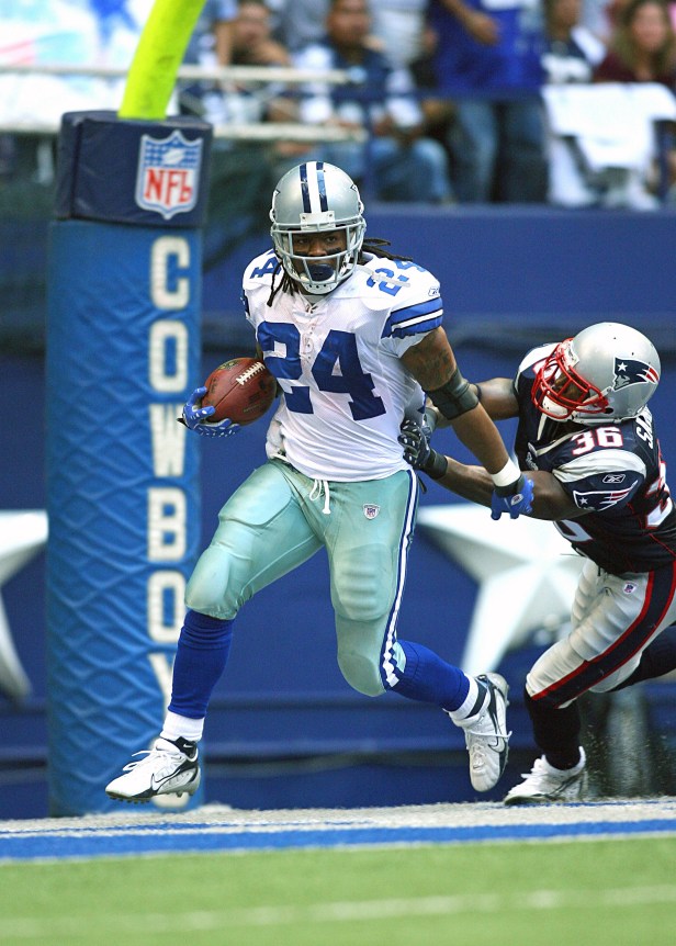 Marion Barber III breaks a tackle against the Patriots in 2007.