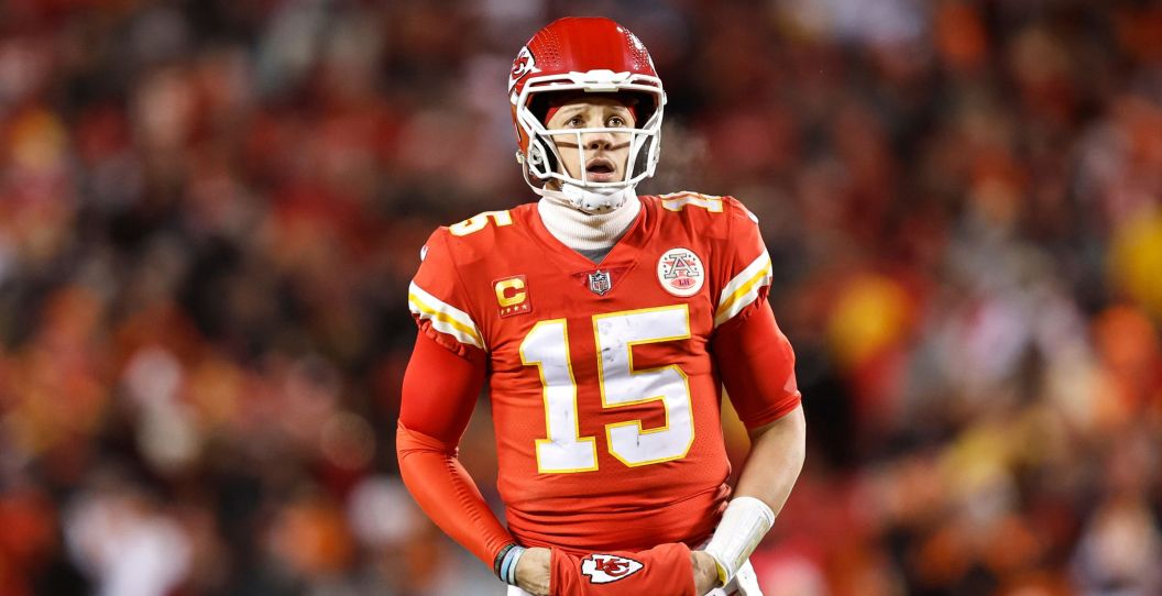 Patrick Mahomes warms his hands in a playoff game.