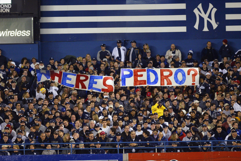 Fans in the bleachers hold up a sign asking where Boston Red Sox pitcher Pedro Martinez is during game 1 of the Major League Baseball World Series between the New York Yankees and the Florida Marlins