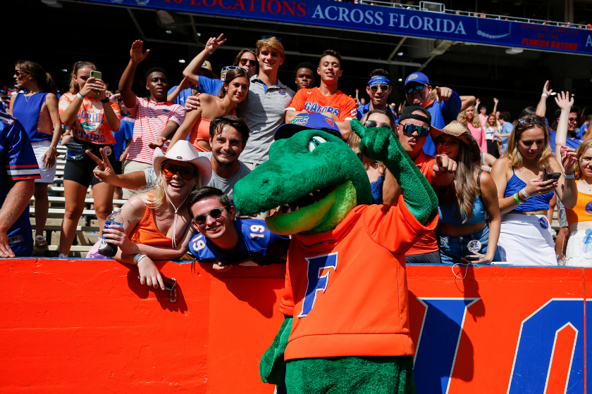 Albert the Alligator posing with fans at The Swamp.