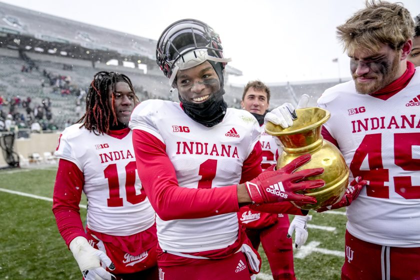 Indiana player holds the old brass spittoon.