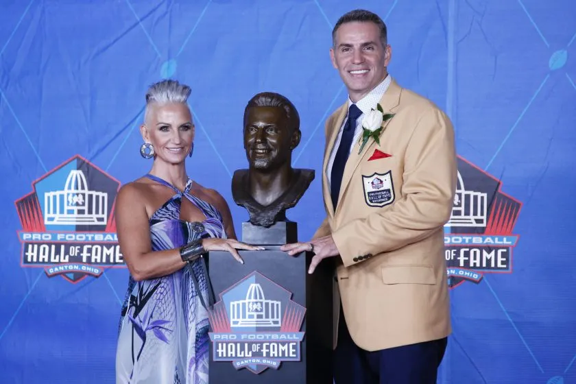 Kurt Warner and wife Brenda Warner pose his bust during the Pro Football Hall of Fame Enshrinement Ceremony.