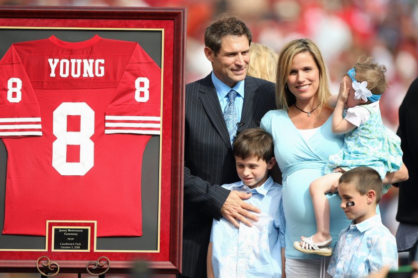 Former San Francisco 49ers quarterback Steve Young poses for picture with his family during a ceremony to retire his number.