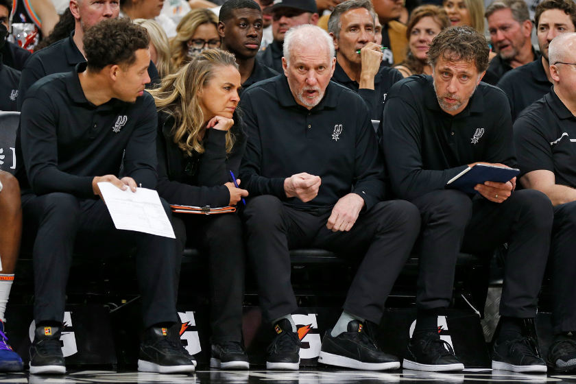 San Antonio Spurs head coach Gregg Popovich strategizes with his coaching staff.